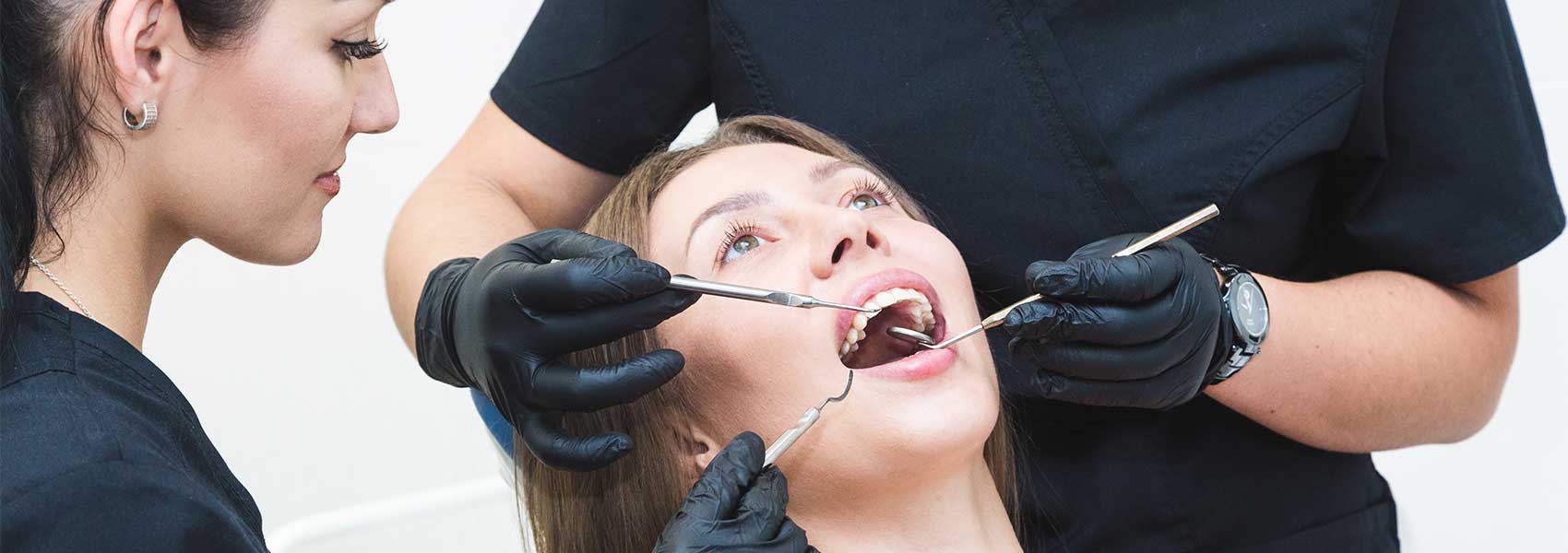 A dental team perform dental restoration treatment for their patient